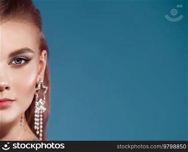 Portrait beautiful woman with jewelry. Beauty fashion. Eyelashes. Cosmetic eyeshadow. Care and beauty hair products