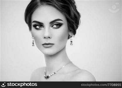 Portrait Beautiful Woman with Jewelry. Fashion Makeup and Cosmetics. Elegant Hairstyle. Beauty and Accessories. Black and white photo