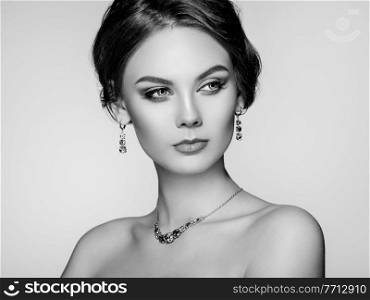 Portrait Beautiful Woman with Jewelry. Fashion Makeup and Cosmetics. Elegant Hairstyle. Beauty and Accessories. Black and white photo
