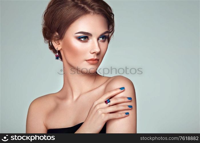 Portrait Beautiful Woman with Jewelry. Model Girl with Blue Manicure on Nails. Elegant Hairstyle. Blue Make-up Arrows. Beauty and Accessories