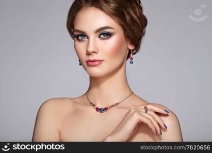 Portrait Beautiful Woman with Jewelry. Model Girl with Blue Manicure on Nails. Elegant Hairstyle. Blue Make-up Arrows. Beauty and Accessories