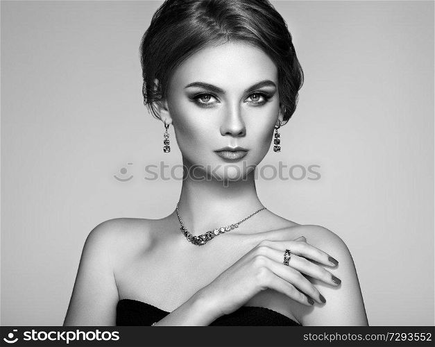 Portrait Beautiful Woman with Jewelry. Model Girl with Magnificent Manicure on Nails. Elegant Hairstyle. Fashion Make-up Arrows. Beauty and Accessories