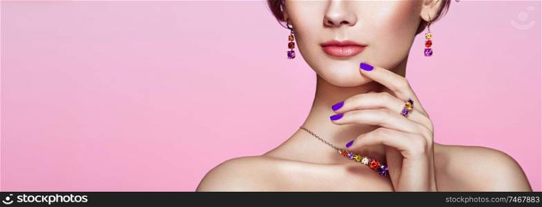 Portrait beautiful woman with jewelry. Model girl with violet manicure on nails. Beauty and Accessories. Pink lipstick