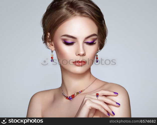 Portrait Beautiful Woman with Jewelry. Model Girl with Violet Manicure on Nails. Elegant Hairstyle. Violet Make-up Arrows. Beauty and Accessories