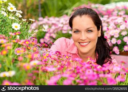 Portrait beautiful woman with purple daisy flowers in garden center