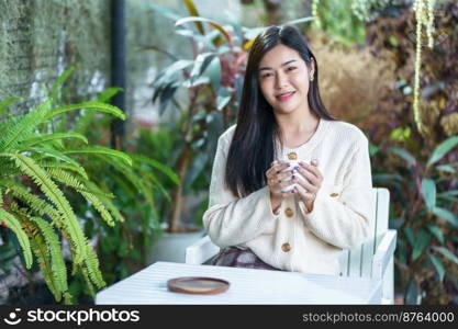 Portrait beautiful young asian woman girl wearing warm clothes enjoys drinking holding of positive the having cup of coffee,milk or chocolate at house home in the living room inside or cafe