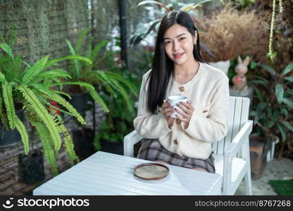 Portrait beautiful young asian woman girl wearing warm clothes enjoys drinking holding of positive the having cup of coffee,milk or chocolate at house home in the living room inside or cafe