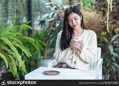 Portrait beautiful young asian woman girl wearing warm clothes enjoys drinking holding of positive the having cup of coffee,milk or chocolate at house home in the living room inside or cafe