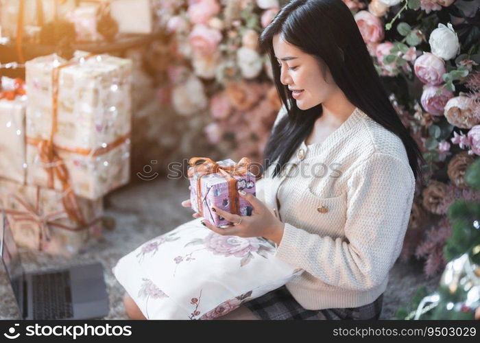 Portrait beautiful young asian woman girl wearing warm clothes exchanging gifts and Give a present at house home in the living room inside or cafe,During Christmas x-mas and New Year holidays.