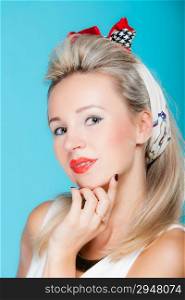 Portrait beautiful young blonde woman in pin-up retro style vintage styling on vivid blue background