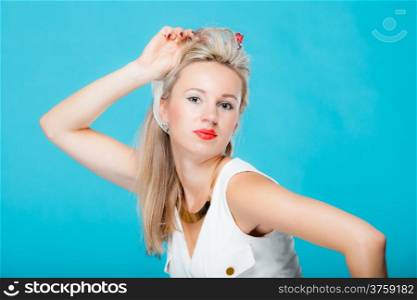 Portrait beautiful young blonde woman in pin-up retro style vintage styling on blue background