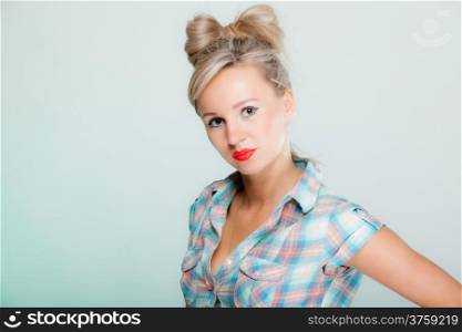 Portrait beautiful young blonde woman in pin-up retro style vintage styling on green background
