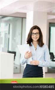 Portrait beautiful young businesswoman holding spiral book in office