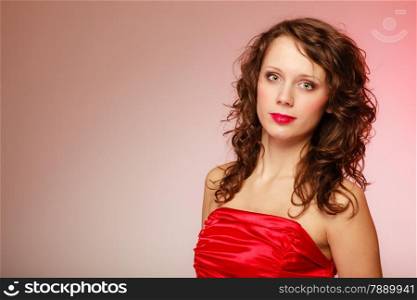 Portrait beautiful young fashion woman smiling teen girl in red dress on pink background