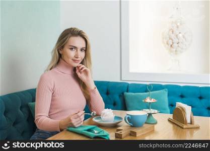 portrait beautiful young woman sitting cafe looking camera