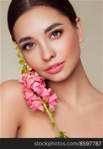 Portrait beautiful young woman with clean fresh skin. Model with healthy skin, close up portrait. Cosmetology, beauty and spa. Girl with a pink  flower