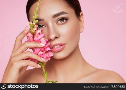 Portrait beautiful young woman with clean fresh skin. Model with healthy skin, close up portrait. Cosmetology, beauty and spa. Girl with a pink  flower