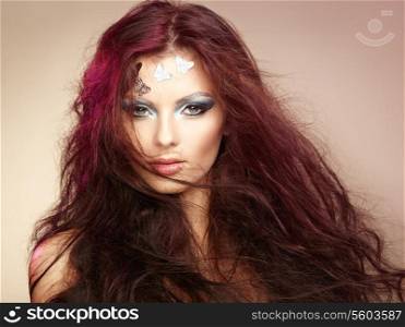 Portrait beautiful young woman with flying hair. Makeup with butterflies