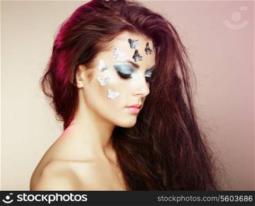 Portrait beautiful young woman with flying hair. Makeup with butterflies