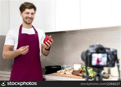 portrait blogger recording cooking video home