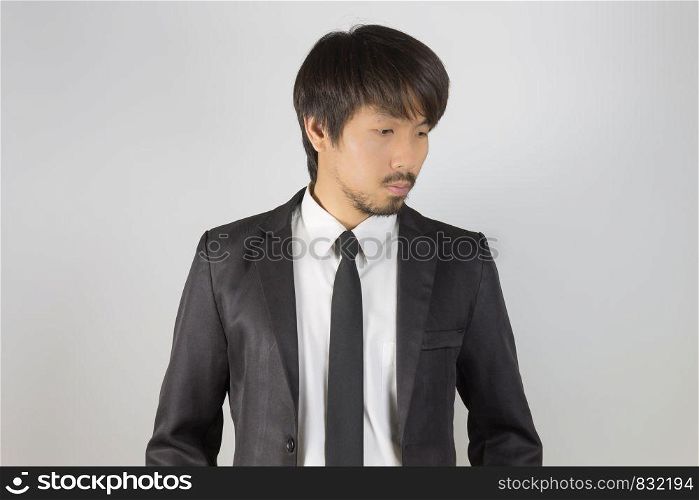 Portrait Businessman in Black Suit Fashion Looking Below. Portrait businessman wear white shirt and suit in smart pose style