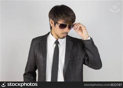 Portrait Businessman in Black Suit Touching Eyeglasses or Eyewear. Portrait businessman wear white shirt and suit in smart pose style