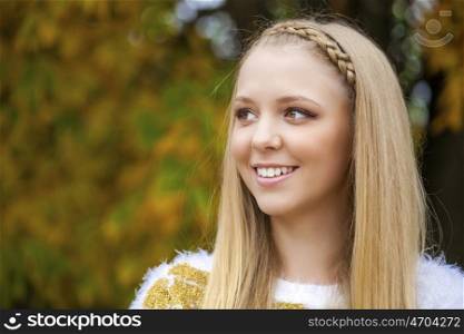Portrait close up of young beautiful blonde women, on golden background autumn nature