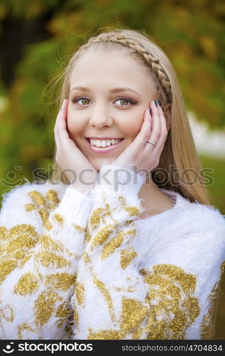 Portrait close up of young beautiful blonde women, on golden background autumn nature