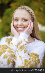 Portrait close up of young beautiful blonde women, on golden background autumn nature