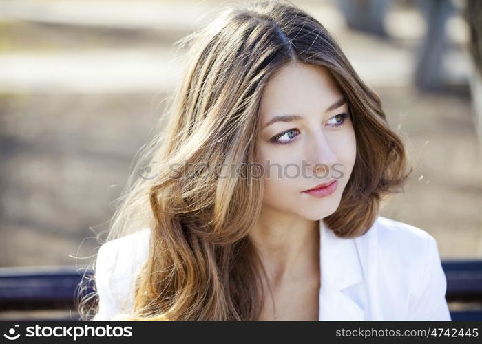 Portrait close up of young beautiful girl, on background spring street