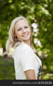 Portrait close up of young beautiful woman, on green background summer nature