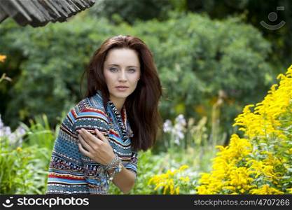 Portrait close up of young beautiful woman, on green background summer nature
