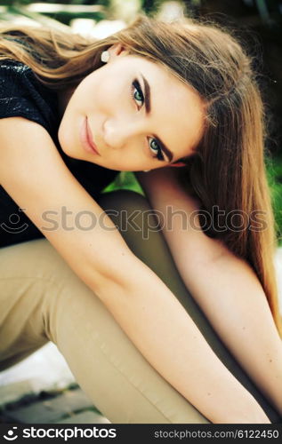 Portrait close up of young beautiful woman, on green background summer nature. Beautiful girl with ombre hair and clean face