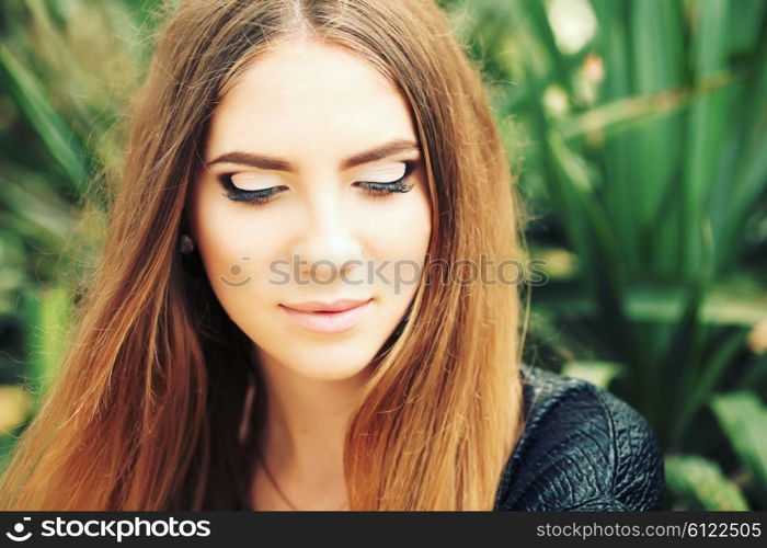 Portrait close up of young beautiful woman, on green background summer nature. Beautiful girl with ombre hair and clean face