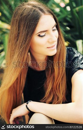Portrait close up of young beautiful woman, on green background summer nature. Beautiful girl with ombre hair and clean face