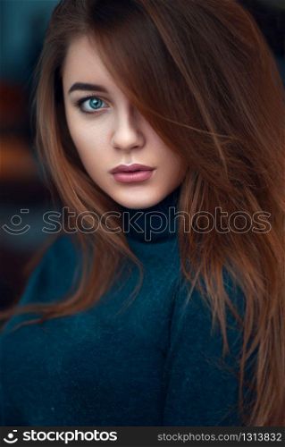Portrait close up of young glamour woman with long beautiful hair on blur background.