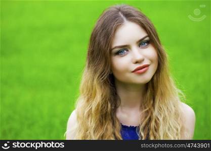 Portrait close up of young happy beautiful woman, on background summer street