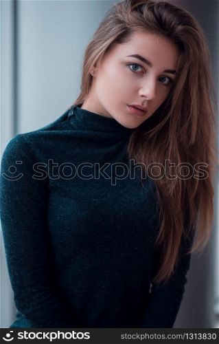 Portrait closeup of young glamour woman with long beautiful hair on blur background.. Portrait close up of glamour woman with long hair.
