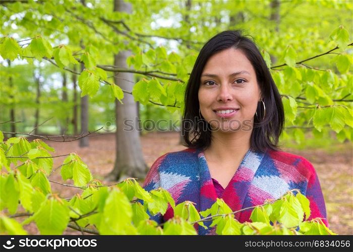 Portrait colombian woman with green leaves in spring season