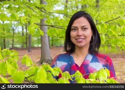 Portrait colombian woman with green leaves in spring season