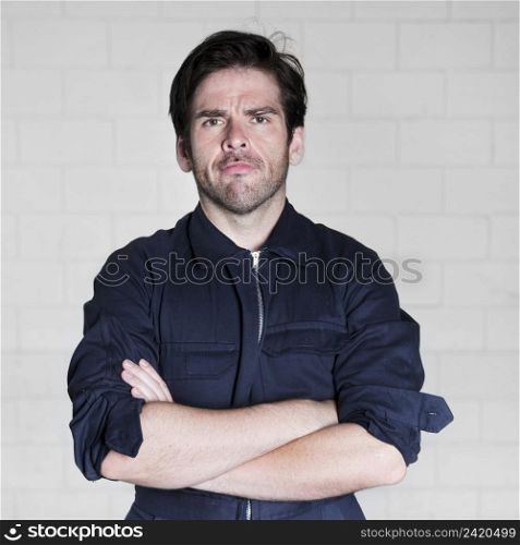 portrait confident male electrician standing against wall
