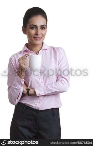 Portrait confident young businesswoman holding coffee cup over white background