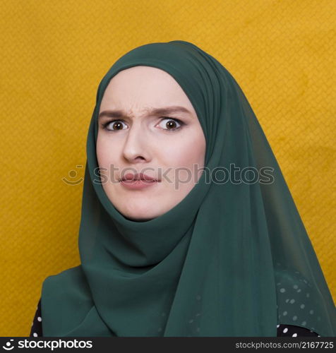 portrait confused woman looking camera against yellow backdrop