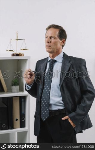 portrait contemplated mature lawyer with hand his pocket