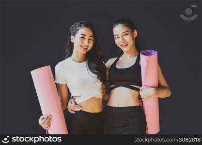 Portrait Couple sporty asian woman standing and smiling, wearing sportswear bra and pants fashion, posture position, sport club community, sports and healthcare concept