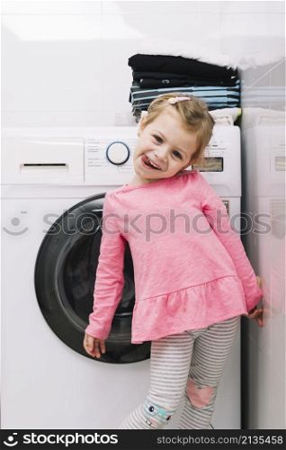 portrait cute girl standing front washing machine
