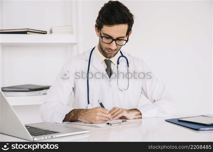 portrait doctor writing clipboard clinic