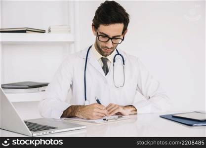 portrait doctor writing clipboard clinic