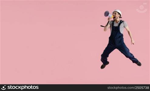 portrait engineer man jumping with megaphone