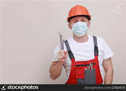 portrait engineer worker or mechanic wearing helmet and face mask for protect virus covid 19 on white background, with holding wrench. portrait engineer worker or mechanic wearing helmet and face mask for protect virus covid 19 on white background, with holding wrench.